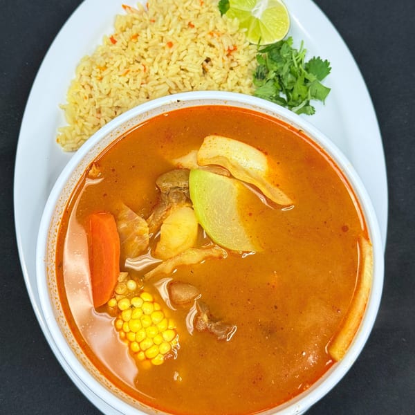 Mi Casita Restaurant's Mexican soup with corn, carrots, and chayote, served with rice, lime, and cilantro.