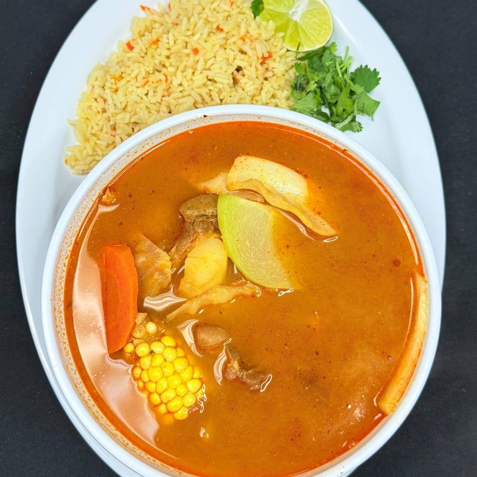 Mi Casita Restaurant's Mexican soup with corn, carrots, and chayote, served with rice, lime, and cilantro.